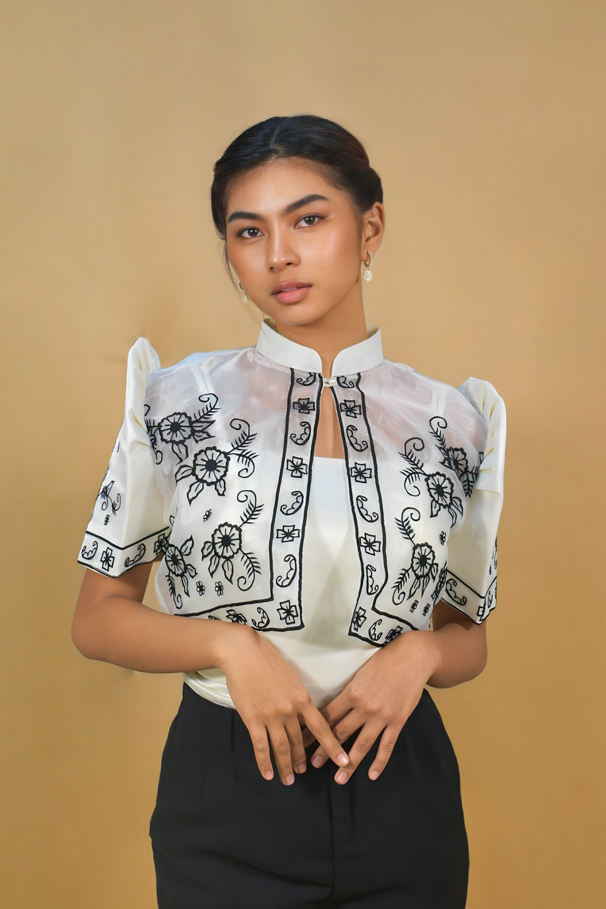 White Filipiniana bolero with butterfly sleeves worn as an open jacket