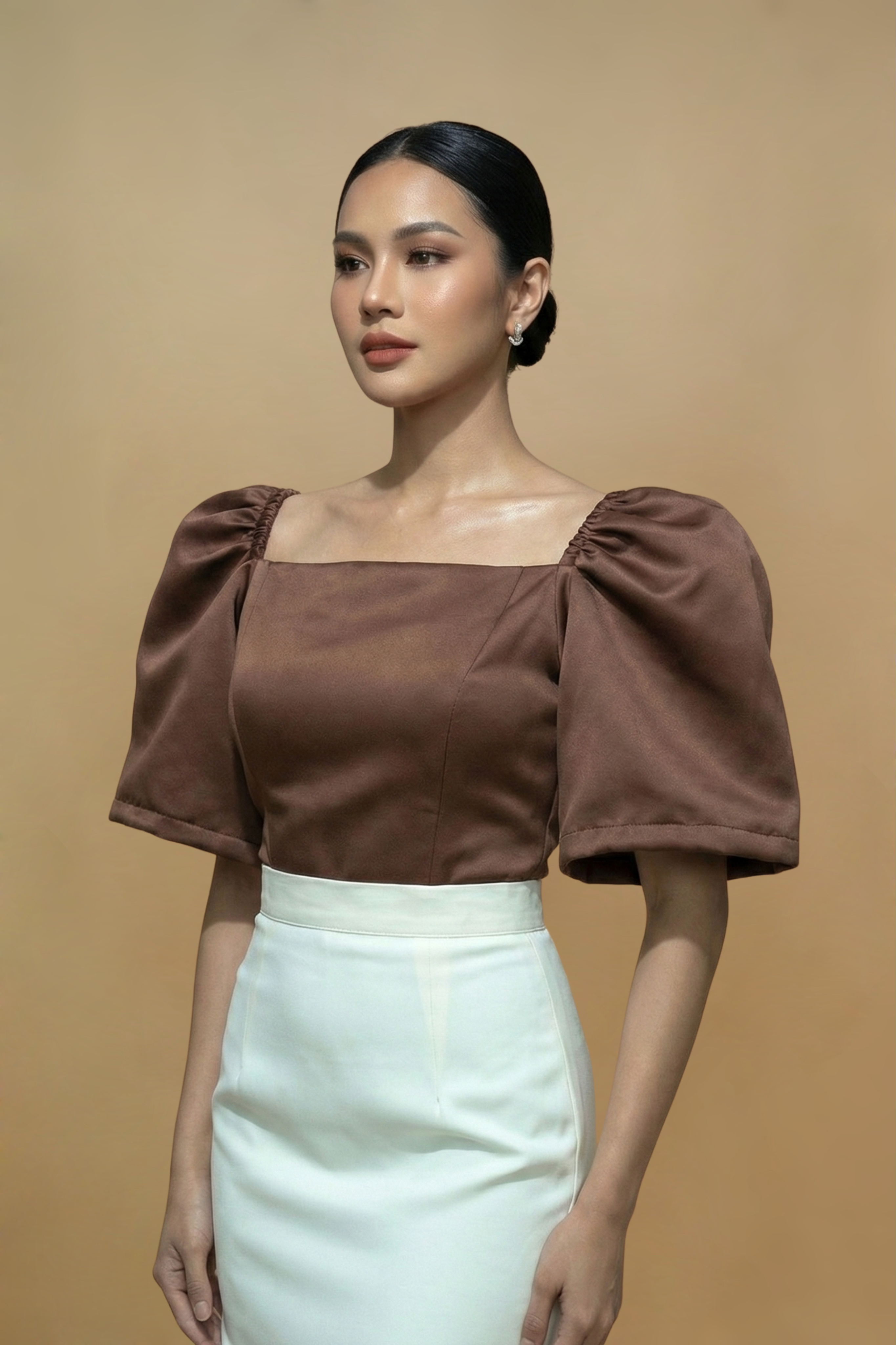 Brown Filipiniana Kimona top with puffed sleeves and a white skirt on a beige background